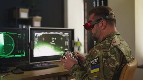 Ukrainian serviceman flying FPV drone carrying payload in command center Stock Footage 333307978