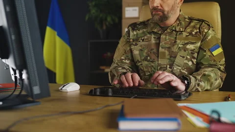 Ukrainian serviceman typing on keyboard in office, handling strategic tasks Stock Footage 333306988
