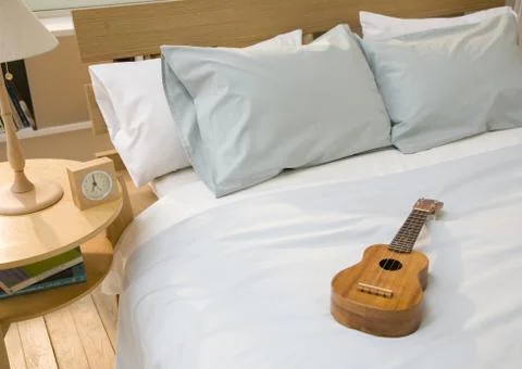 Ukulele on bed Stock Photos