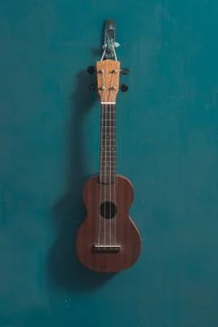 Ukulele in front view with isolated blue background Foto stock