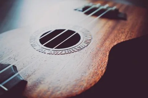Ukulele guitar macro view, strings close up. Photo depicts musical instrument Stock Photos