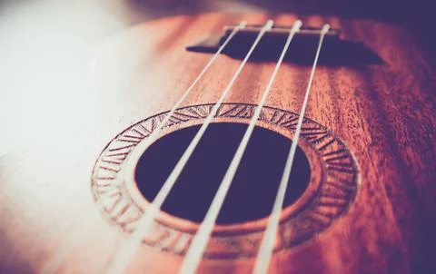 Ukulele guitar macro view, strings close up. Photo depicts musical instrument Stock Photos