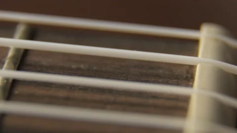 Ukulele neck fingerboard and strings close-up shot. Vídeos de archivo 155142786