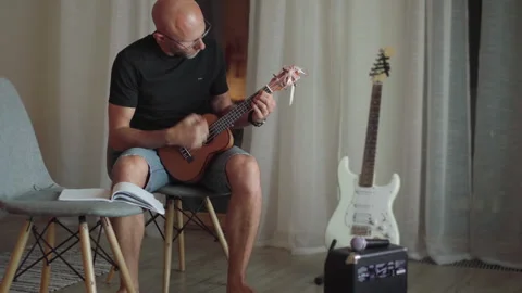 Ukulele string instrument video popular on Hawaii islands. Man playing nylon str Stock-Footage 295310533