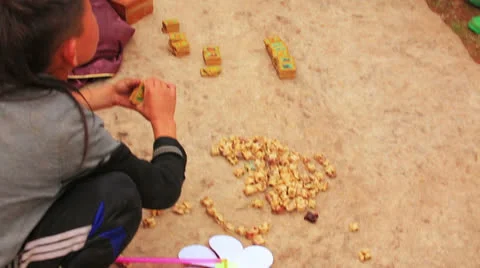 ULAANBAATAR, MONGOLIA - JULY 2013: people playing Knucklebone Stock Footage 32425792