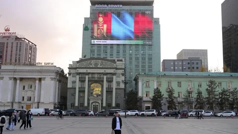 Ulaanbaatar Mongolia: Pedestrians at Sukhbaatar Square &amp; Digital Flag on Bogd Stock Footage 328401941
