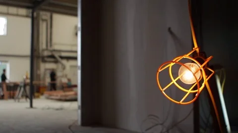 Ull focus from an industrial light bulb to background construction site 動画素材 78769835