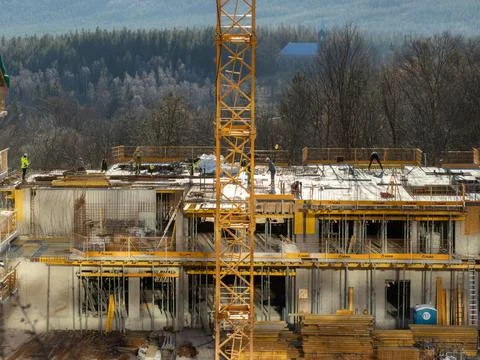 Ulma construction site featuring a tall yellow crane and workers building a Stock Photos