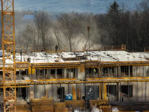 Ulma construction site featuring a tall tower crane and workers on a concrete Stock Photos