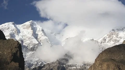 Ultar Day, Time lapse of clouds moving over snow covered mountain 스톡 동영상 47750325