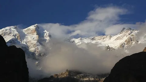 Ultar, Time lapse video of clouds forming and moving over snow covered mountain  스톡 동영상 47750473