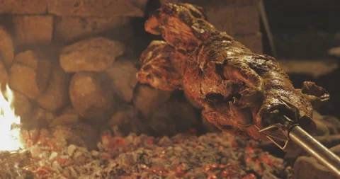 The Ultimate Outdoor Feast: Spit-Roasting a Whole Pig to Perfection Stock Footage 221649215