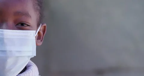 Ultra close-up portrait view of a young Black African girl wearing a facemark Stock Footage 133922741