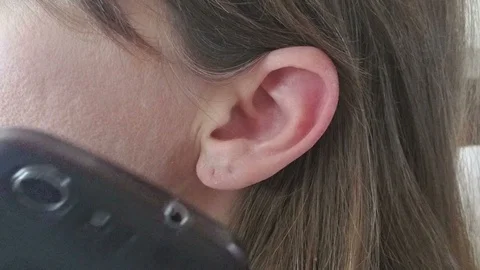 Ultra ECU of Ear and Cell Phone Answered with Head Movement and Then Cellular Stock Footage 87027744