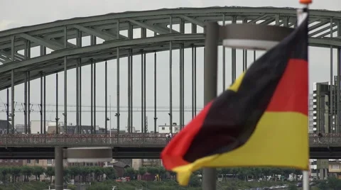ULTRA HD 4K German flag wave Hohenzollern bridge train pass landmark Koln city Stock Footage 40543580
