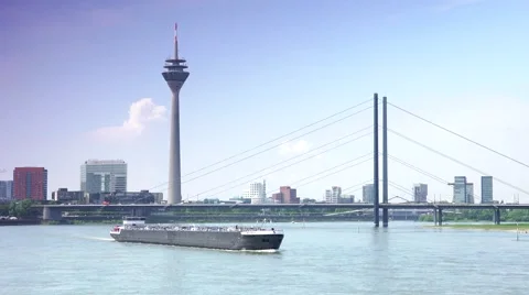 ULTRA HD 4K real time,Barge sails of the river Rhine by bridge in Dusseldorf Stock Footage