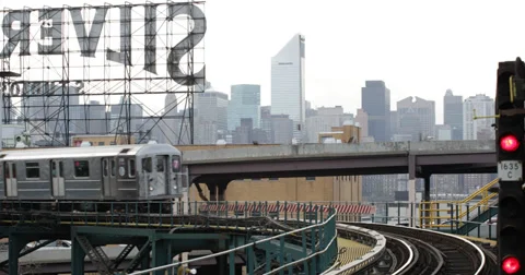 Ultra HD 4K Subway Train Passing Elevated Line in Queens New York City Skyline Stock Footage