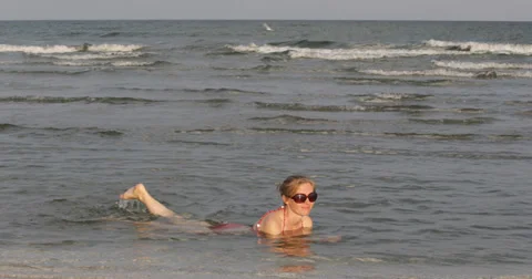 Ultra HD 4K Young Pretty Girl Woman Swimming in Sea Ocean Waves Floating Summer Stock Footage 32246933