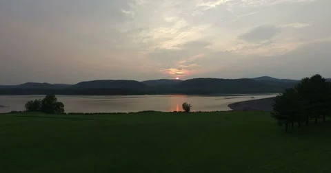 Ultra HD - The Sun Sets Behind the Mountains and Lake as the Moves Forward 스톡 동영상 52136299