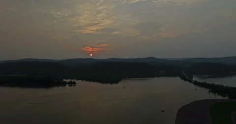 Ultra HD - The Sun Sets as Camera Pans Towards Village Video stock 52137318