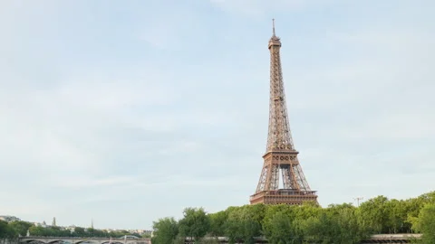 Ultra Sharp 4K Cinematic Shot of the Eiffel Tower Looming over Green Trees and t Stock Footage 338326901