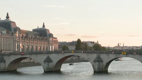Ultra-sharp 4K wide shot of a classic stone arch bridge crossing the Seine River Stock Footage 338174157
