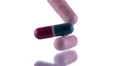 ultra Slo mo extreme close up colorful pills drop onto glass white background HD 影片