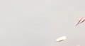 ultra slo mo pennies drop on glass white background high angle HD Footage