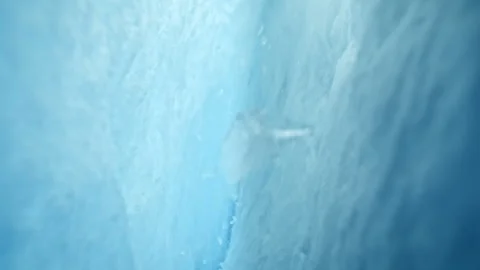 Ultra Slow Motion Camera Passing Through Glacier Ice Crack With Falling Ice. Stock Footage 327786874