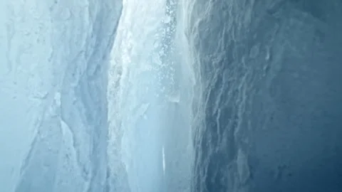 Ultra Slow Motion Camera Passing Through Glacier Ice Crack With Falling Ice. Stock Footage 331403781
