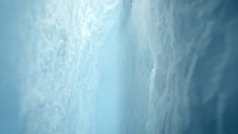 Ultra Slow Motion Camera Passing Through Glacier Ice Crack With Falling Ice. Stock Footage 331960871