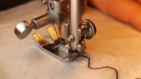 Ultra slow motion of sewing machine making a pattern with thread on white Stock Footage 110967316