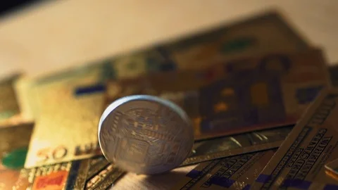 Ultra slowmotion. Camera moving around bitcoin coins and golden money dollars Stock Footage 104326474