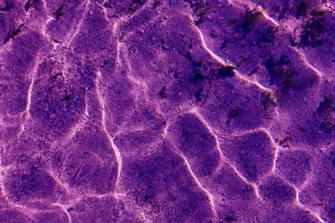 Ultra violet Pattern of ripple wave with sun reflection Stock Photos