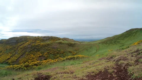 Ultra-wide view on pathway between two peaks, Arthurs Seat ancient volcano on Stock Footage 240134252