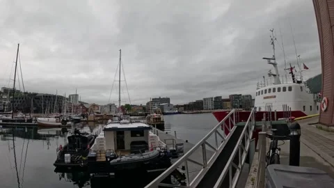 Ultra wide view of Tromso harbor marina quay gangway and docked ships Norway 動画素材 341697373