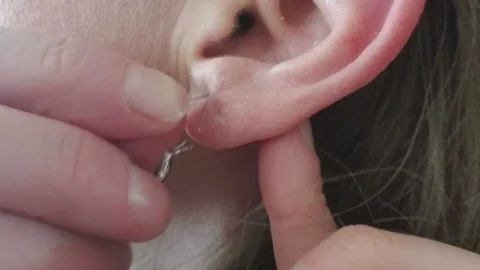 UltraExtreme Close-Up of Earring Being Put through Lobe Hole to Be Worn Stock Footage 87027257