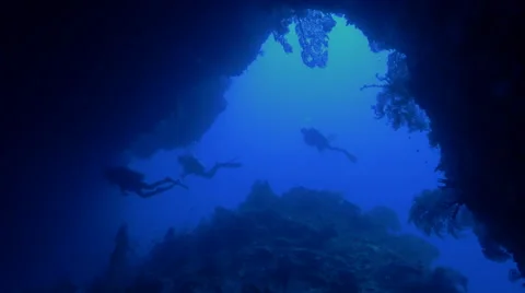 UltraHD scuba divers enter an huge uw cave, Palau Stock Footage 47136493