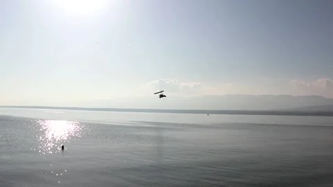 Ultralight flying low at beach Stock Footage 172503409