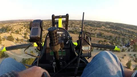 Ultralight pilot flying low over cedar tree desert HD 040 Stock Footage 12125834