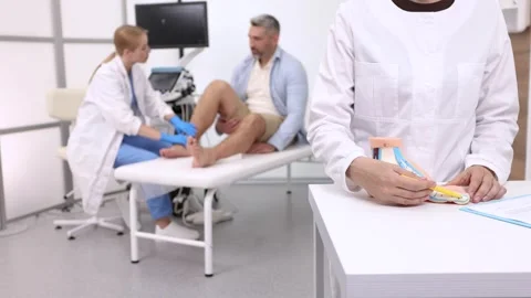 Ultrasonic of ankle joint. Sonographer checking patient ankle using high-freq Stock Footage 318063892