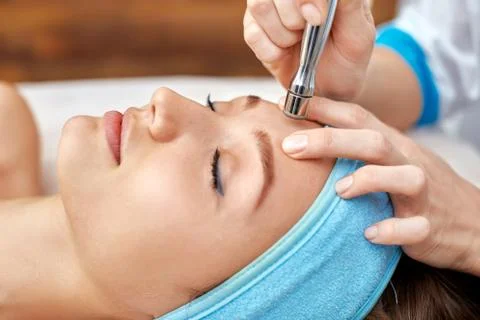 Ultrasonic face cleaning, peeling, in a beauty salon Stock Photos