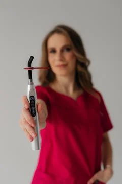 Ultraviolet curing light with UV light blocking glass in hands. Stock Photos
