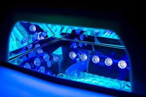 Ultraviolet lamp for drying nails. Inside the working LED-lamp. Stock Photos