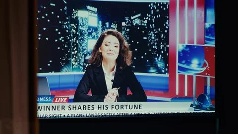 Ultrawide modern TV set in empty living room showing reporter presenting news Stock Photos