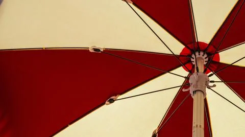 Umbrella beach. Red summer beach parasol on blue sea background. Sun sunshade Stock Photos