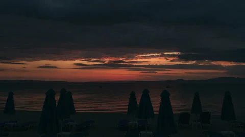 Umbrella on a beach at sunrise timelapse Stock Footage 67206352
