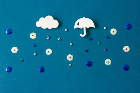 Umbrella, cloud, raindrops falling from sky. Autumn, fall weather raining storm. Stock Photos
