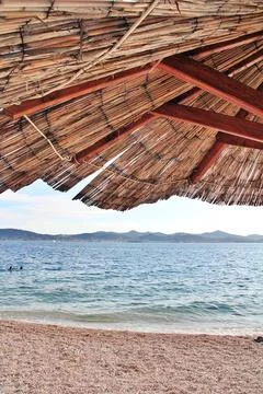 Umbrella on an empty beach Stock Photos