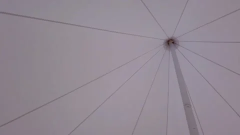 Umbrella in the form of a tent on the beach of the forest lake. Stock-Footage 155659250